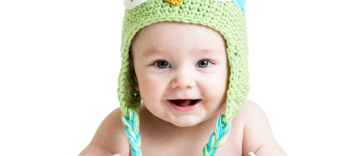 baby in funny knitted hat owl on white background